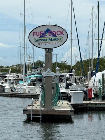 Sunset Marina Key West fuel dock sign with boats and slips in the background