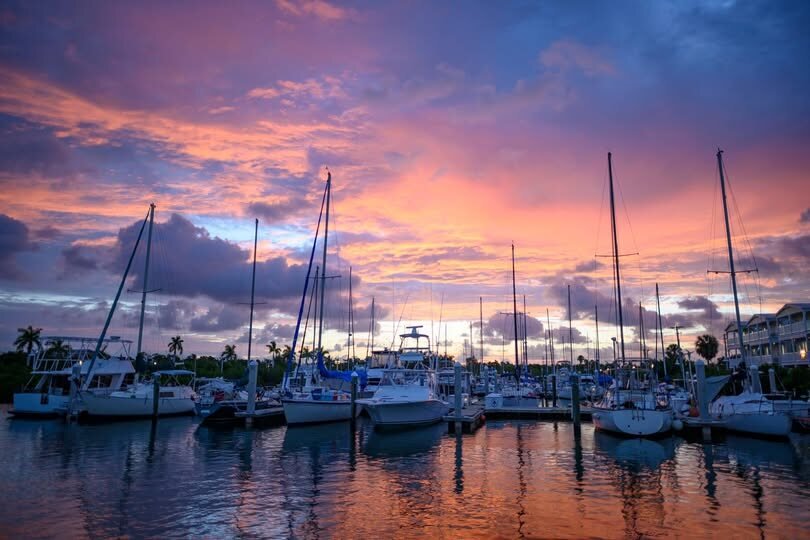 Boats at Sunset Marina under colorful evening skies